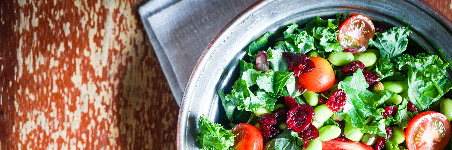 Kale and edamame salad on rustic background