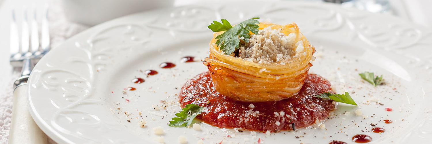 nest of spaghetti with meatballs and tomato sauce